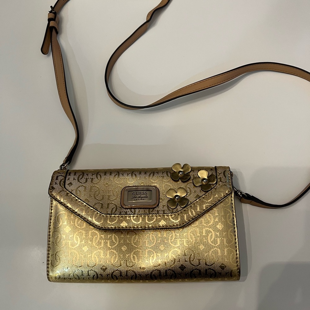Gold Guess shoulder strap purse.